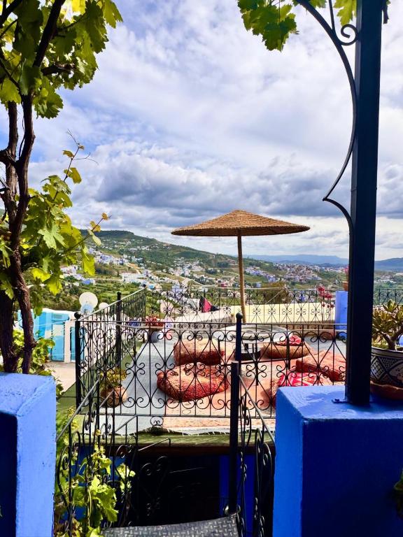 a patio with an umbrella and a pool at Dar Yamina Andalusi in Chefchaouen