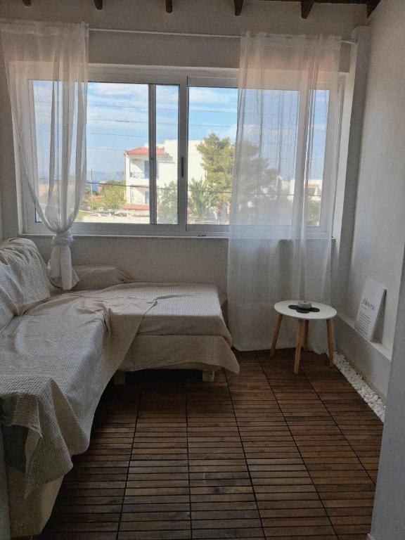 a bedroom with a bed and a large window at Naja's Studio in Souvala