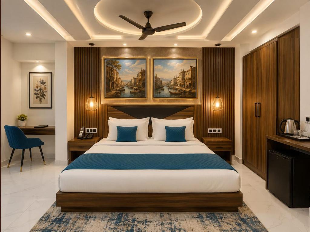 a bedroom with a large bed with a ceiling fan at Hotel CIELO PRIME Near Delhi Airport in New Delhi