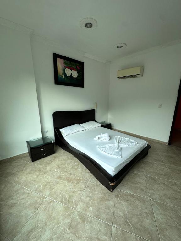 a bedroom with a bed in a room at Hotel Cristalina in Melgar