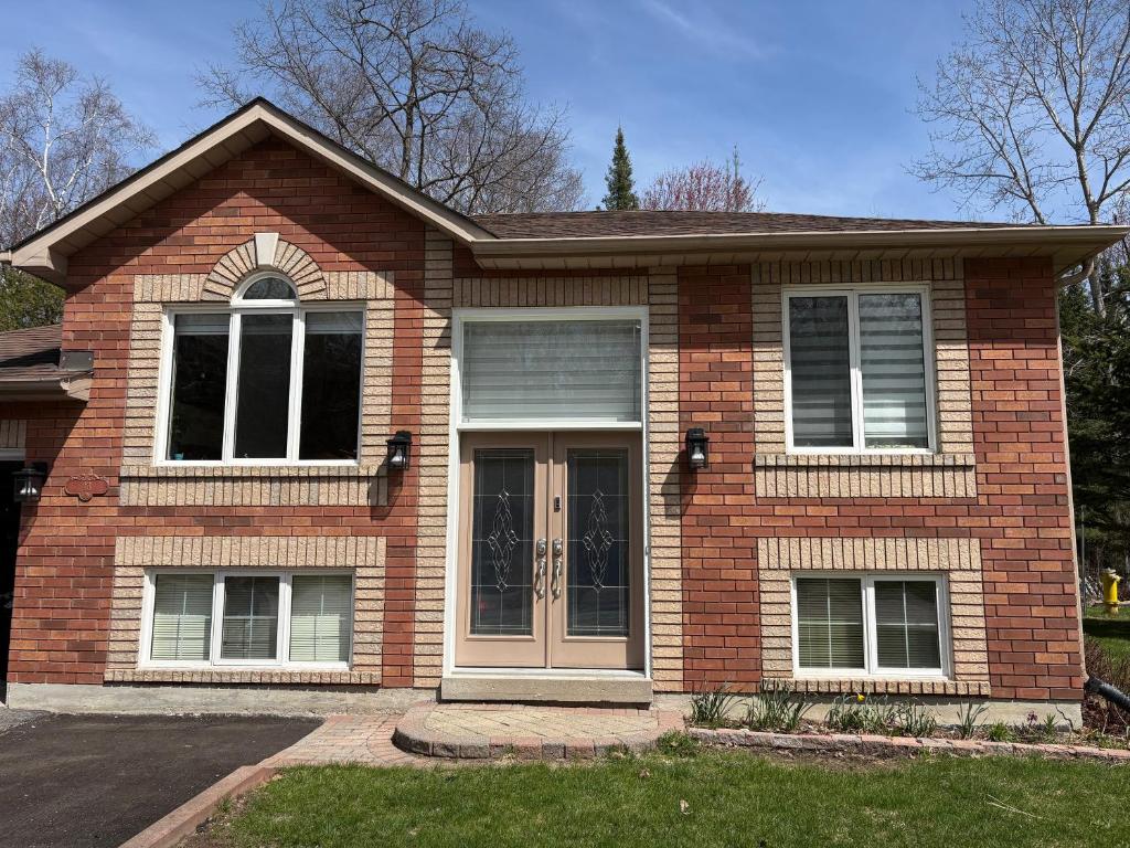 a brick house with a front door and windows at Wasaga Dunes in Wasaga Beach