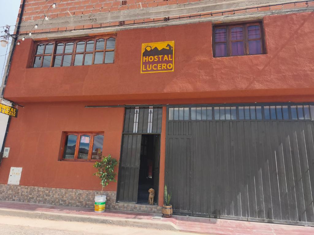 a dog sitting in the doorway of a restaurant at HOSTAL LUCERO in Humahuaca