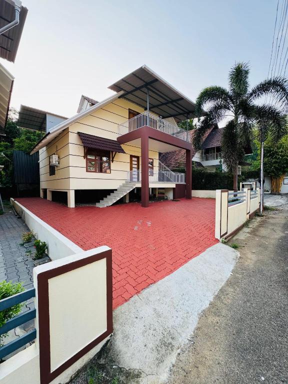 a house with a red carpet in front of it at Iconic villas by ROYAL VILLAS in Athirappilly