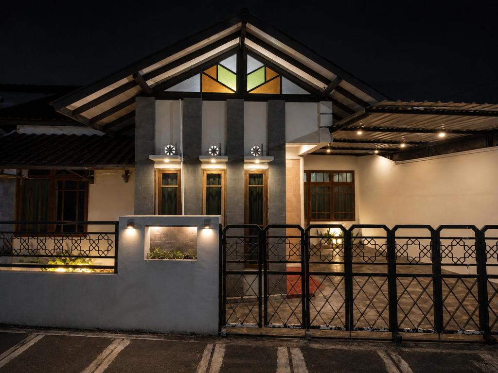 a house with a window and a fence at Abadi Homestay Yogyakarta in Yogyakarta