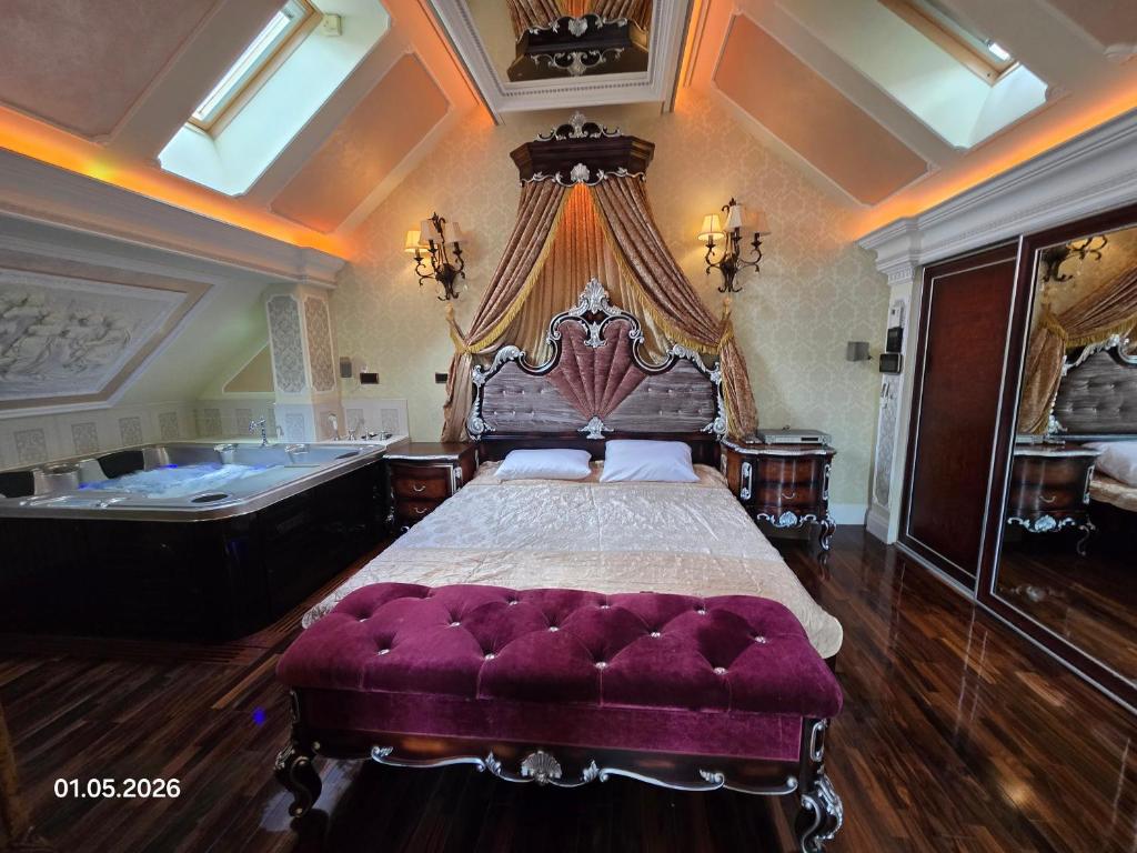 a bedroom with a large bed and a bath tub at PIOTROWSKi HOUSE in Ropica Górna
