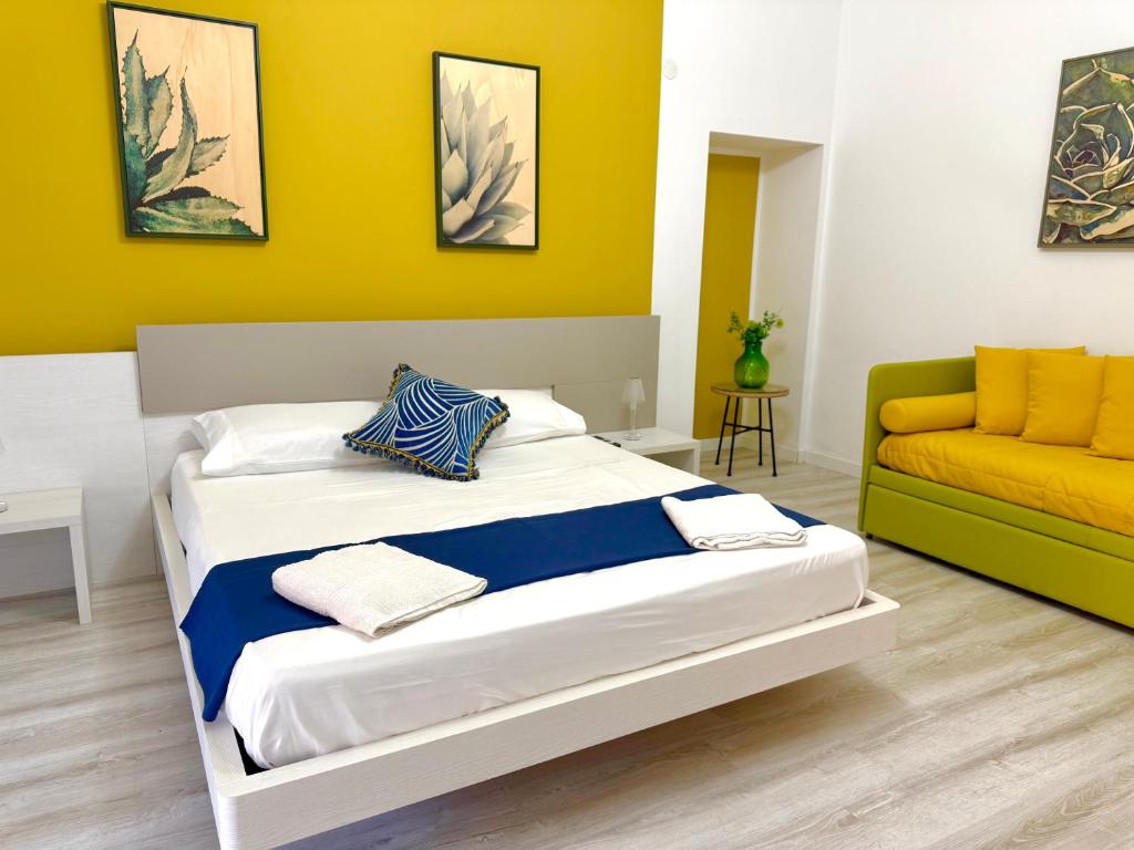 a bedroom with a bed and a couch at Taormina Naxos Home 2 in Giardini Naxos