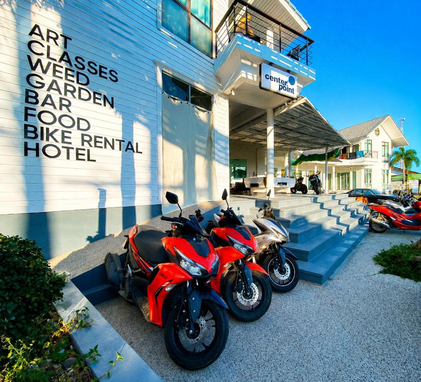 two motorcycles parked in front of a building at Centerpoint Koh Phangan New in Thong Sala