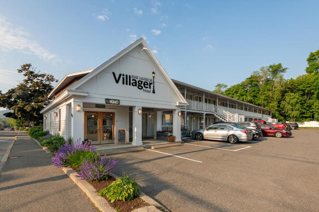 a building with a sign on the front of a parking lot at Bar Harbor Villager Motel - Downtown in Bar Harbor