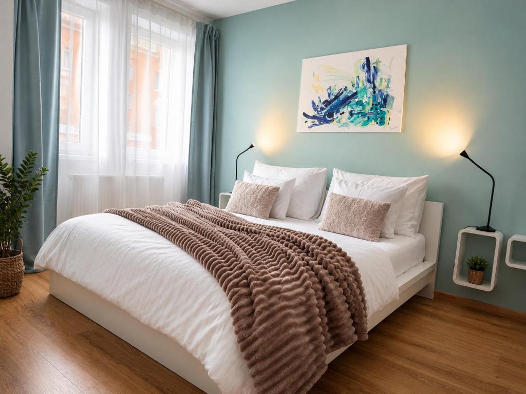a bedroom with a large white bed with a blanket at Apartment Schober - Rezidence K Lanovce in Jáchymov