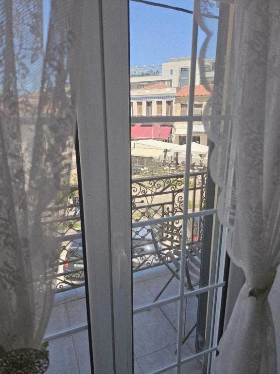 a view of a balcony from a window at Amfitrion on the Town in Gythio