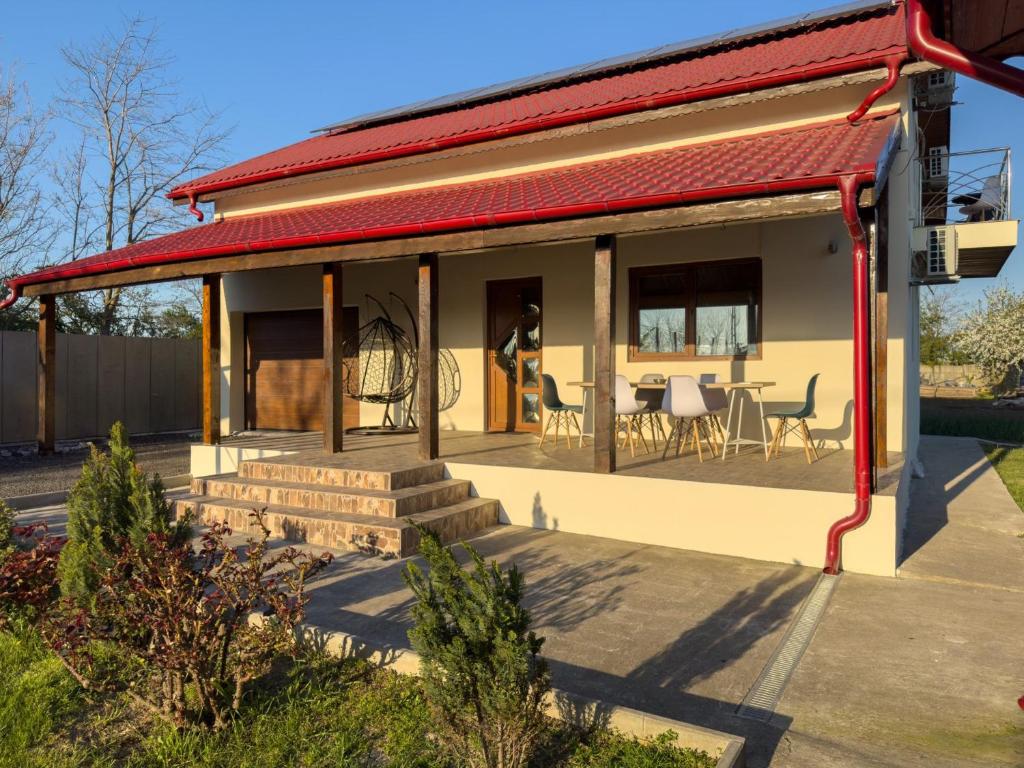 a house with a red roof and a patio at Casa Maia Corbu in Corbu