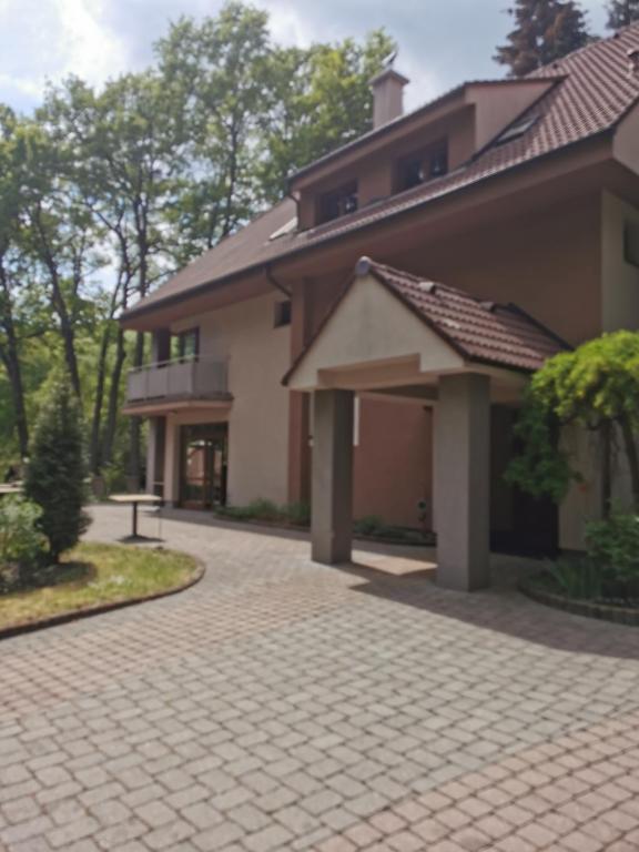 a house with a brick driveway in front of it at ChataKováčová in Kováčová