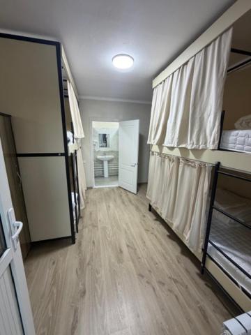 an empty room with a hallway with a room with at Bayan hostel in Osh