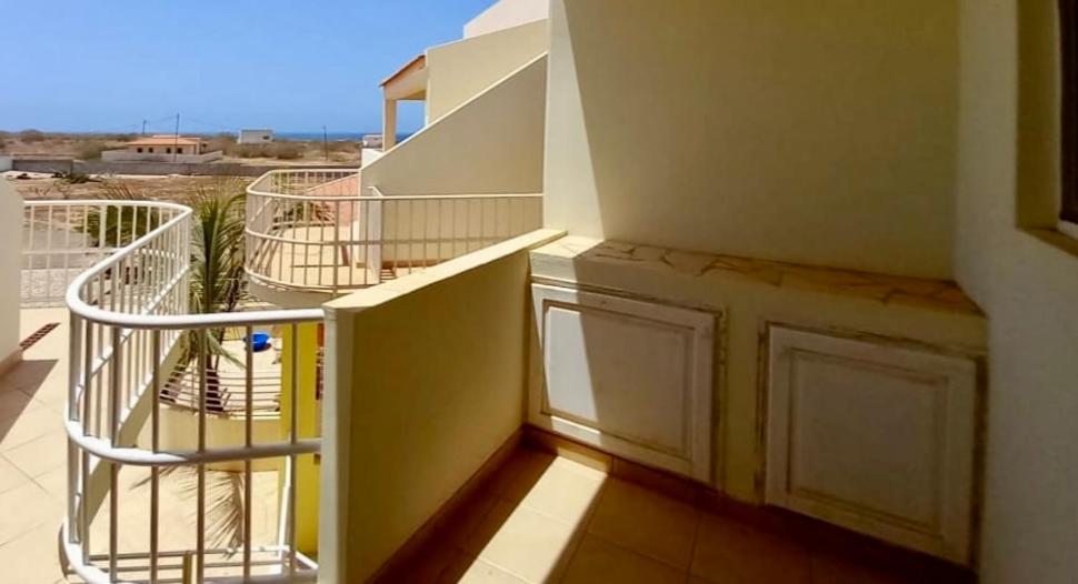 a balcony with a staircase with a view of the desert at Ponta Preta Village 10 in Vila do Porto