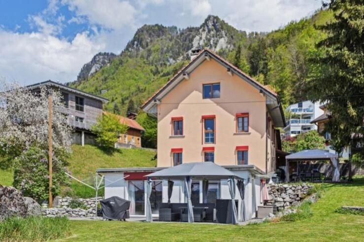 a house with a gazebo in front of a mountain at La Rochetta in Chatel sur Montsalvens