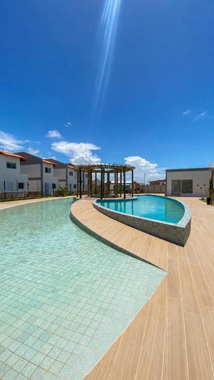 a swimming pool in the middle of a building at Casas Carole Maramar Beach House 35 e 36 in Luis Correia