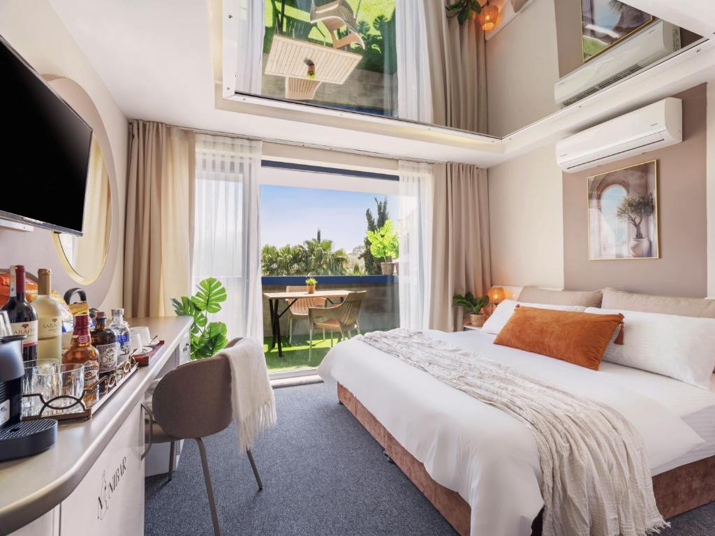 a hotel room with a bed and a balcony at İS Hotel in Antalya