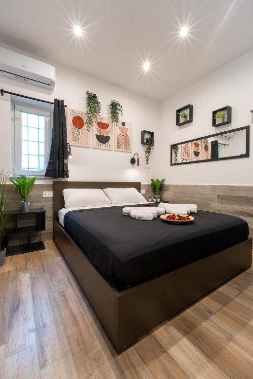a bedroom with a large bed in a room at Suite Gli Ulivi in Colonna