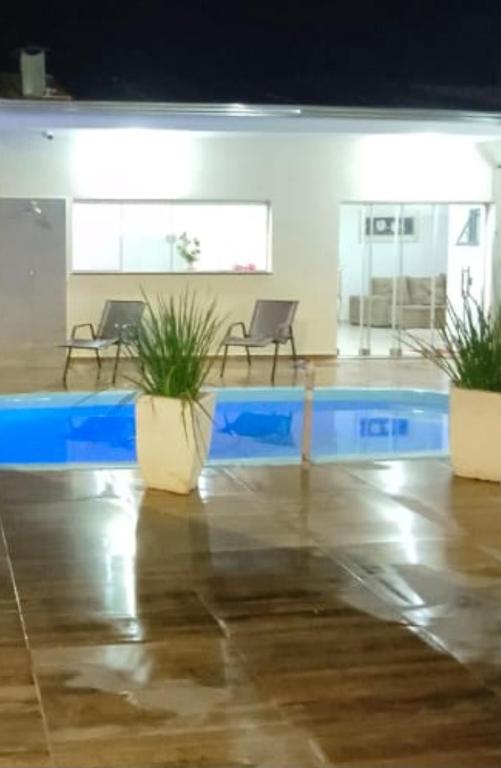 a room with two chairs and a blue table at Recanto Rafaela 2 in Olímpia