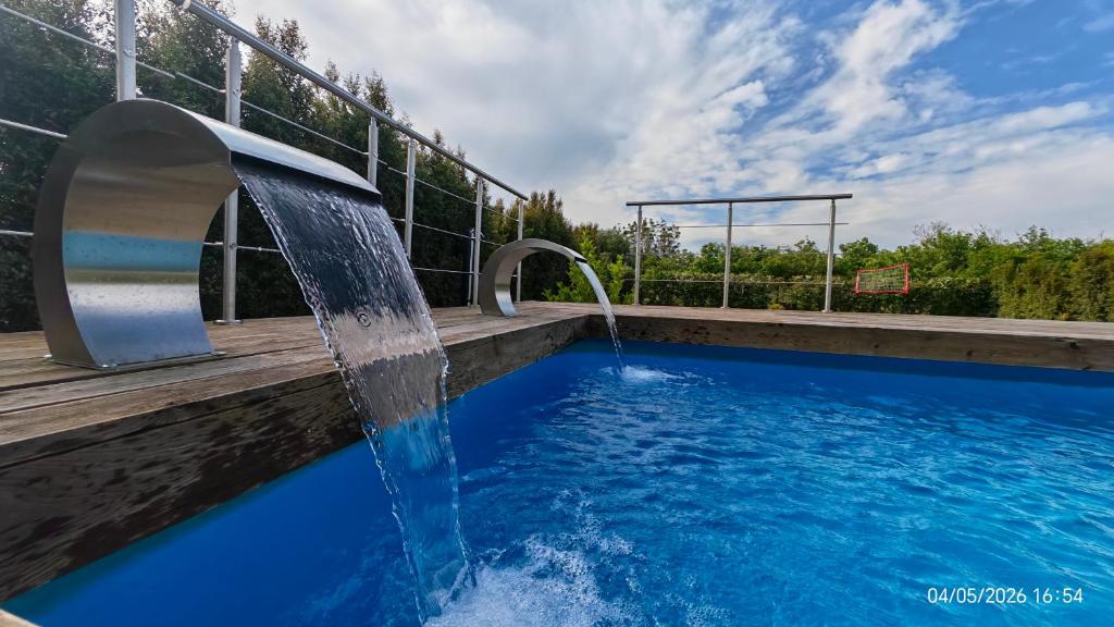 a swimming pool with a water fountain at Domus DEA Holiday Home in Pompei