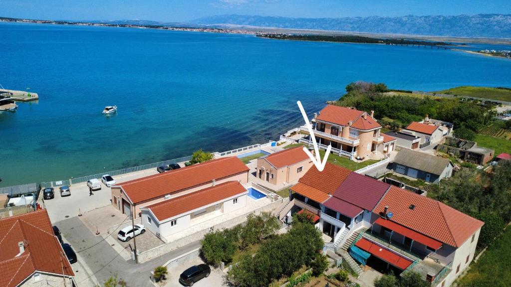 an aerial view of a house next to the water at Apartments Zvonimir in Privlaka