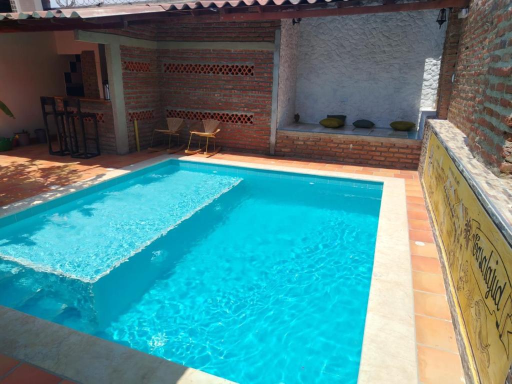 a large swimming pool with blue water at Casalajud Wellness in Taganga