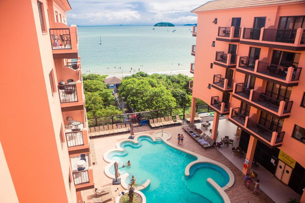 an aerial view of a swimming pool in the middle of a building at Hotel Jurerê Beach Village - OFICIAL in Florianópolis