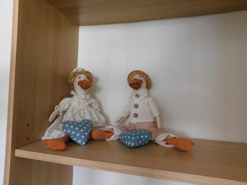 two stuffed animals sitting on a shelf at Gioco dell'oca in Ponna Superiore