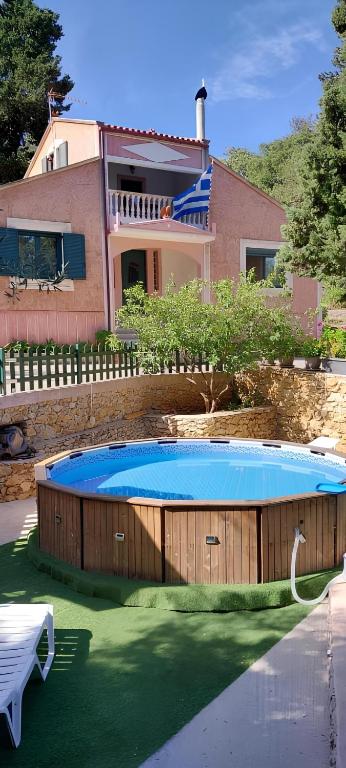 a large swimming pool in front of a house at Anna's Country Villa Privé in Karés