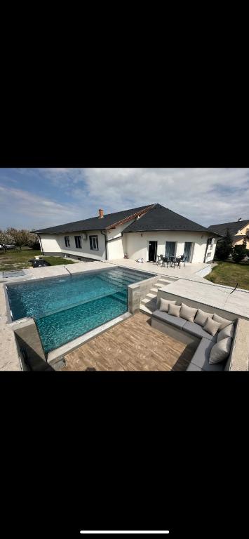 a large swimming pool in front of a house at Reginahouse in Szigetszentmiklós