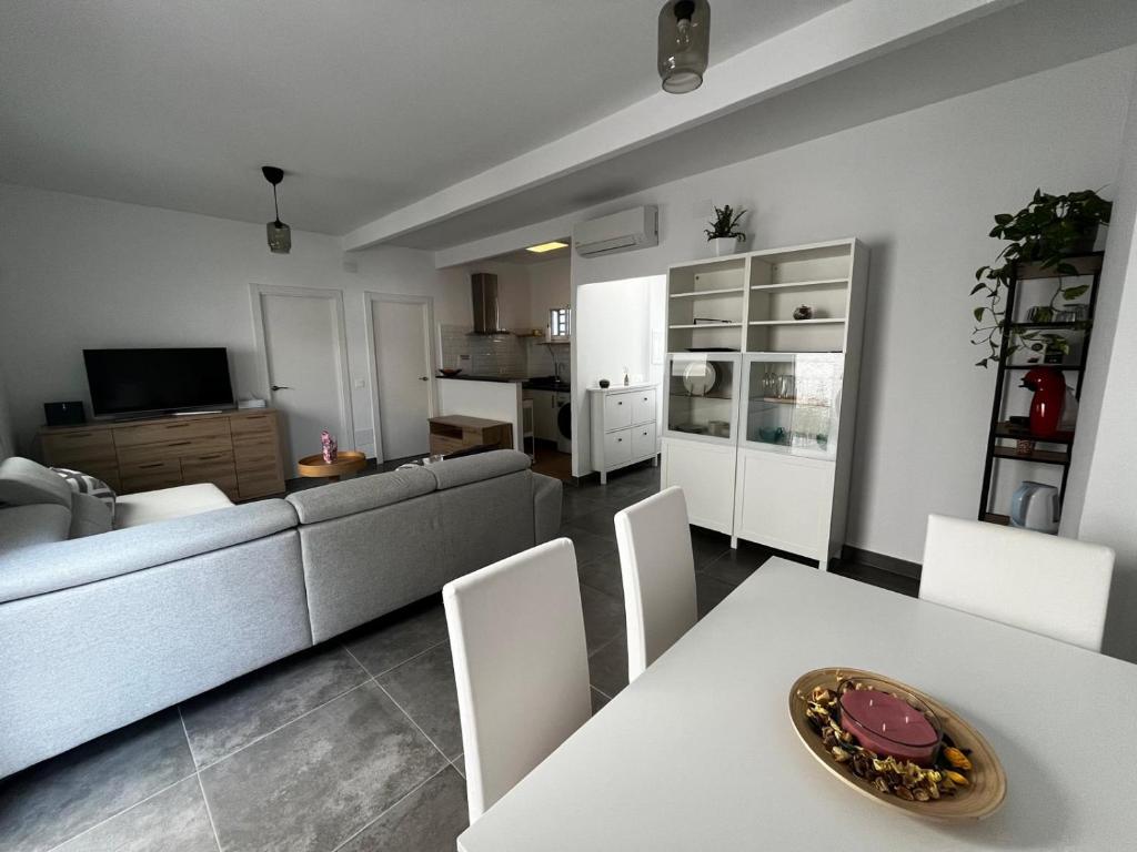 a living room with a couch and a table and chairs at Loresti Mare in Fuengirola