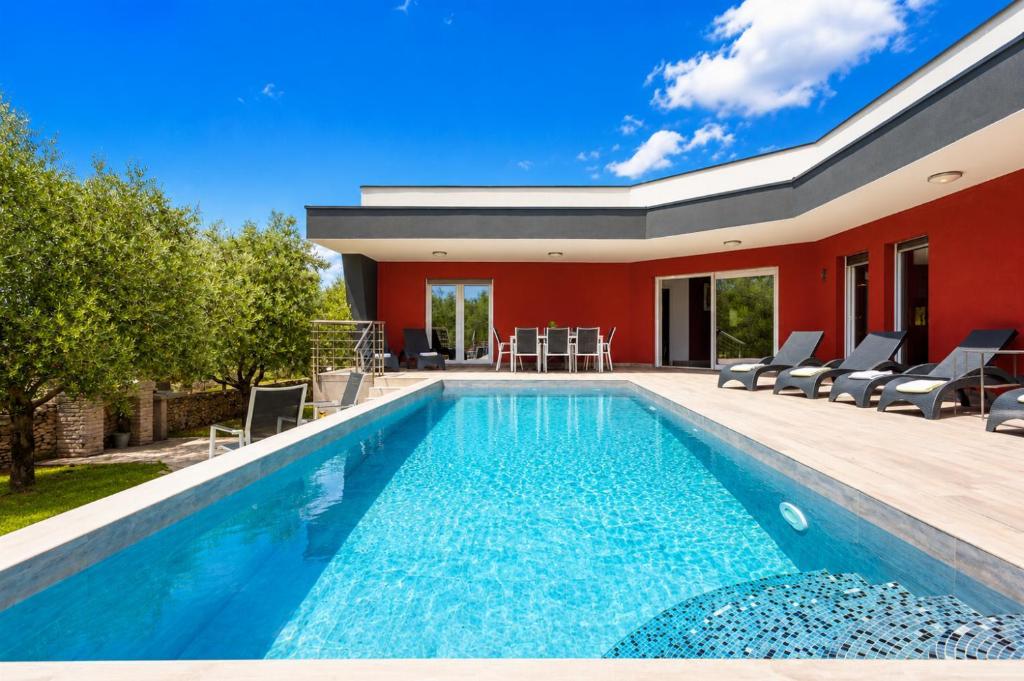 a swimming pool in the backyard of a house at Villa LM in Krnica
