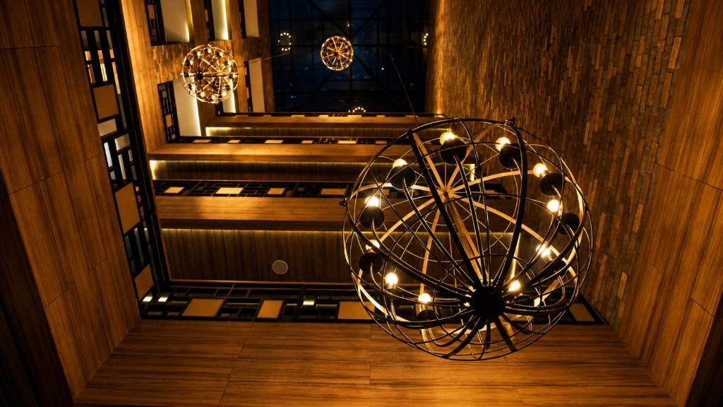 a chandelier with lights in a room with stairs at Hotel Punto MX in Mexico City