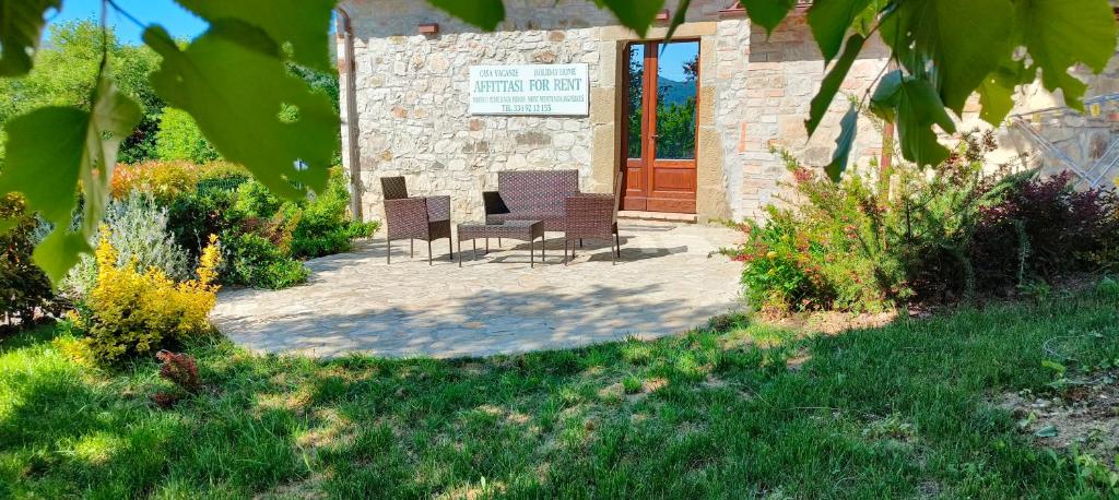 a patio with chairs in front of a building at La Bottega di Torreluca in Todi