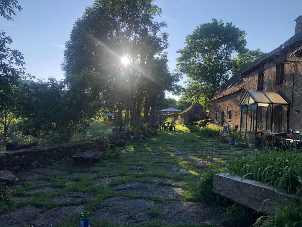 a sun shines on a yard next to a building at The Village in Anzat-le-Luguet