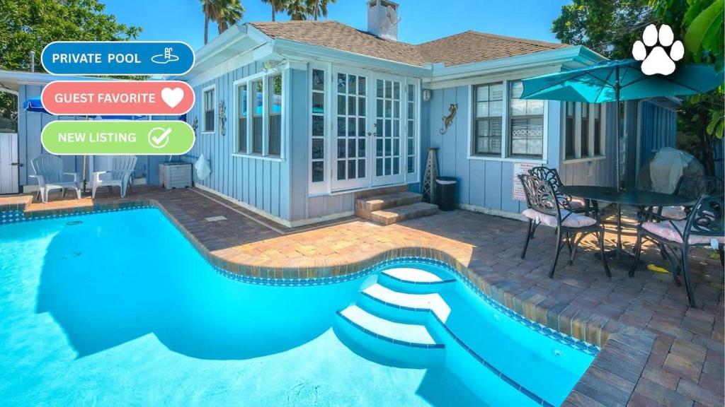 a house with a swimming pool and a house at Coconut Beach House in Clearwater Beach