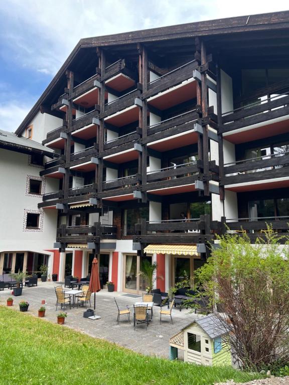 a large building with tables and chairs in front of it at Kronenlodge in Seefeld in Tirol