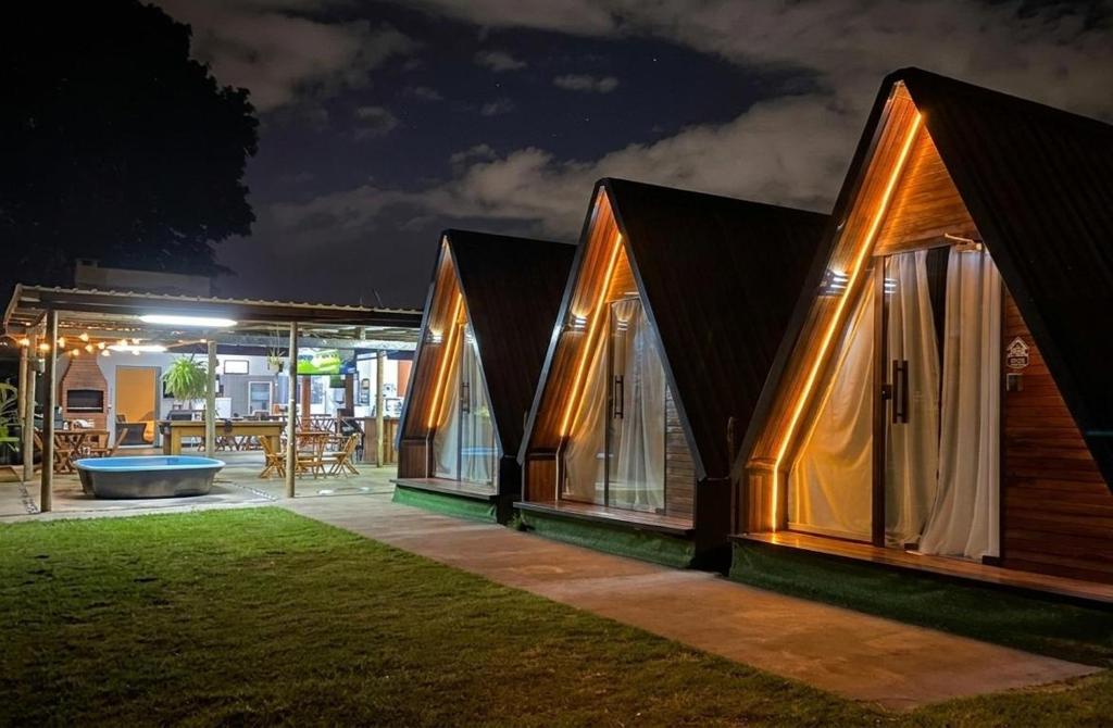 a house with windows and a patio at night at 2205 Chalé Suíte Pousada CadClube in Sao Jose do Rio Preto