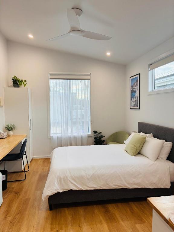 a bedroom with a bed and a desk and a window at Sapphire Beach Studio in Sapphire Beach