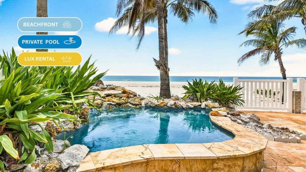 a small swimming pool with a beach in the background at Gulf Front Dreams in Clearwater Beach
