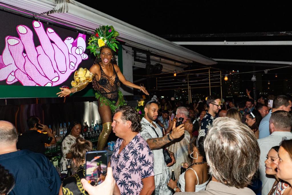 a woman in a crowd of people at a party at Tantalo Hotel - Kitchen - Roofbar in Panama City