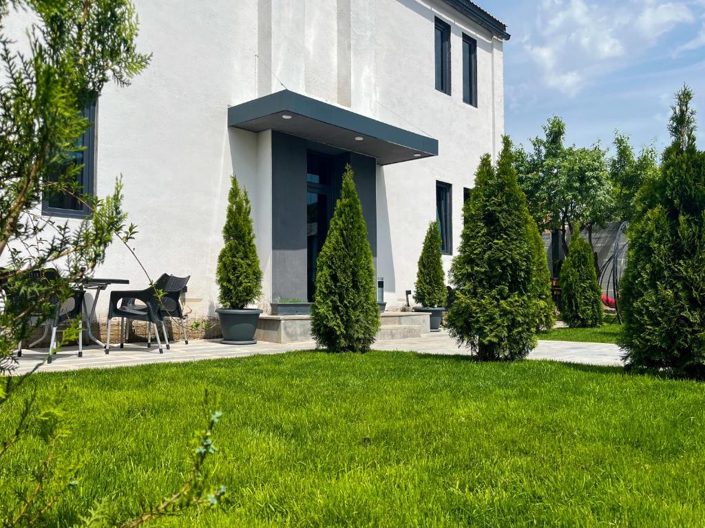 a white house with a lawn in front of it at Haya Guest House in Kʼanakʼerravan