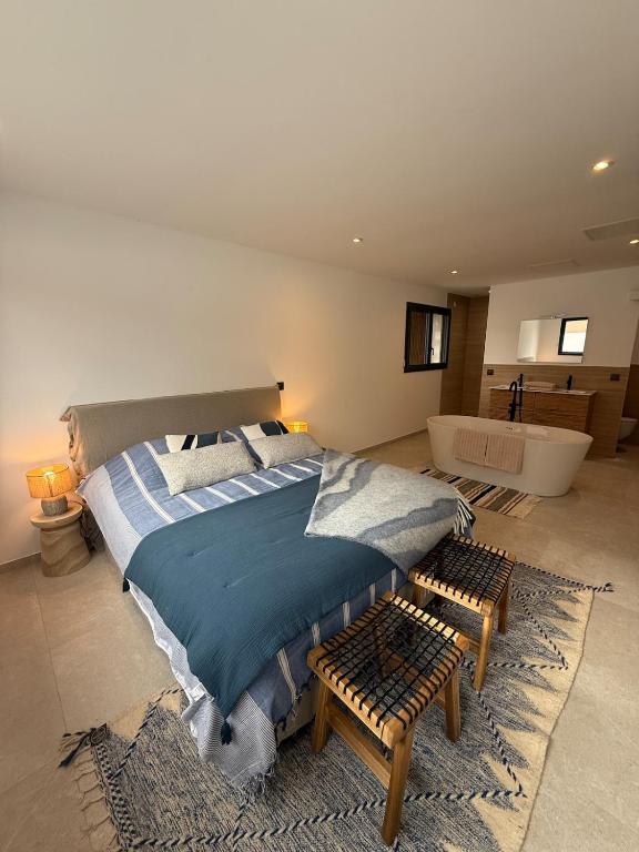 a bedroom with a large bed and a bath room at L'Annexe de la Subérine in Vivès