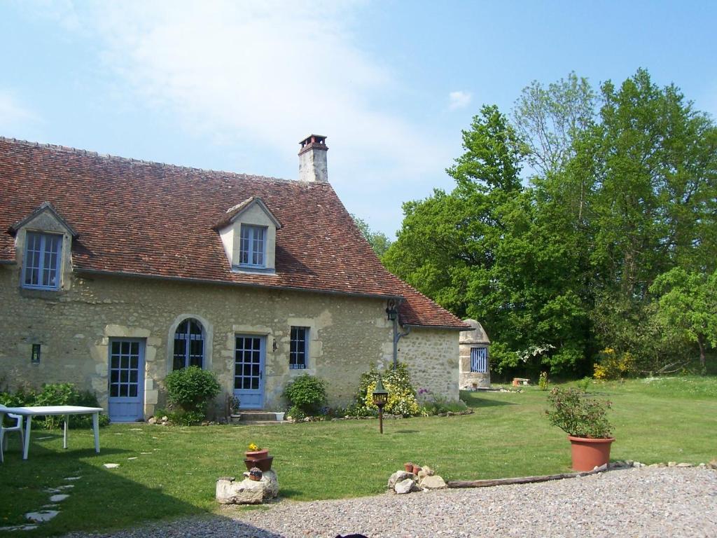 a house with a fire hydrant in front of it at Maison d'Hôtes Les Après in Bellême