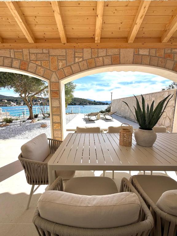an outdoor patio with a wooden table and chairs at Villa Noma in Lovište