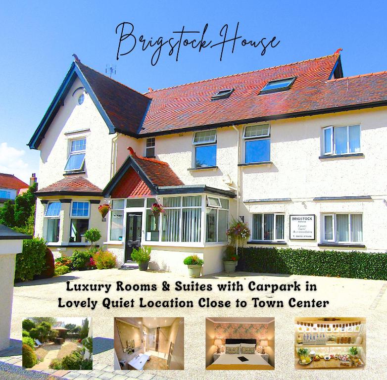 a large white house with a sign in front of it at Brigstock House in Llandudno