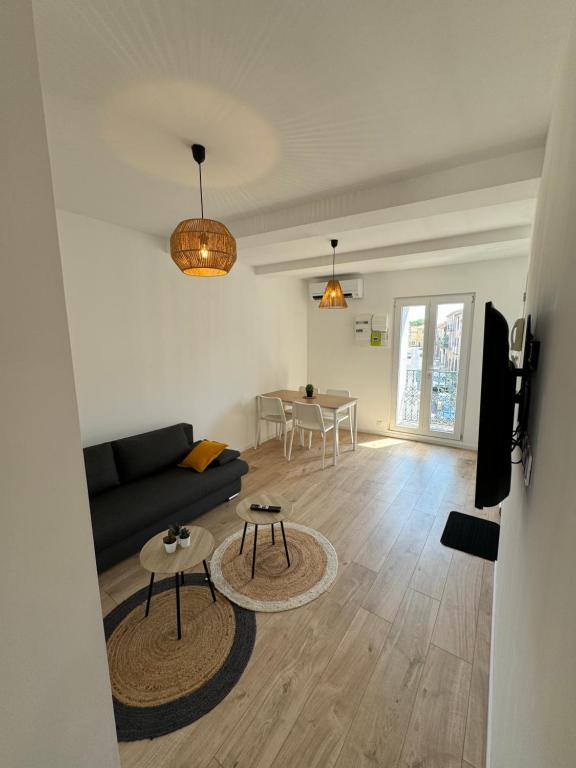 a living room with a couch and a table at Appartements Agde Cap d Agde in Agde