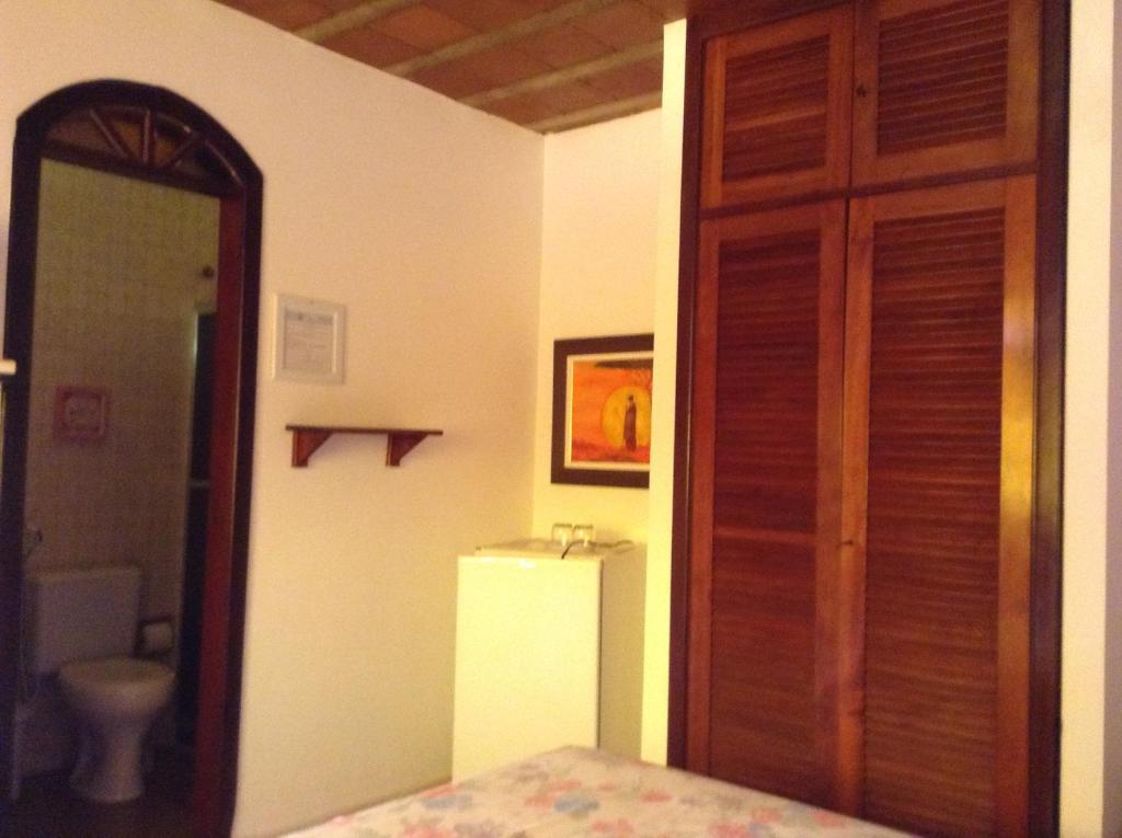 Cama ou camas em um quarto em Rey das Ostras Pousada