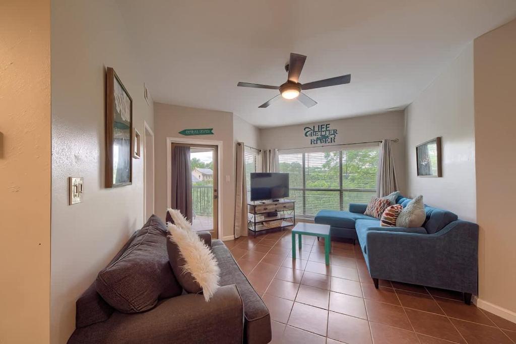 a living room with two couches and a tv at IC 302 Ripley River Haus in New Braunfels