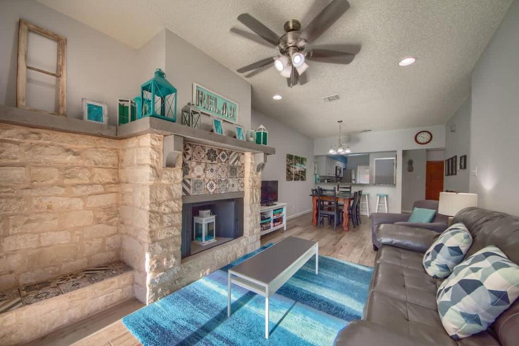a living room with a couch and a fireplace at CW C107 Spritzen Haus in New Braunfels